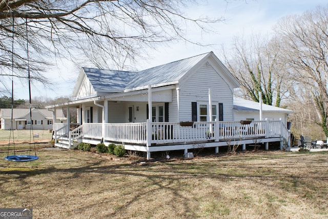 view of side of home with a lawn and a trampoline