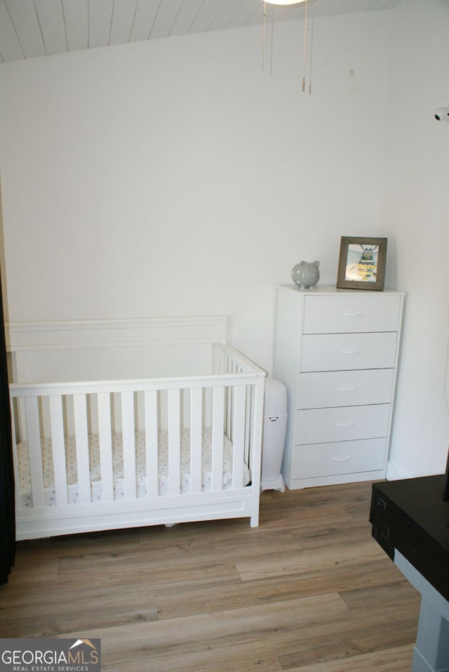 bedroom with wood ceiling and wood finished floors