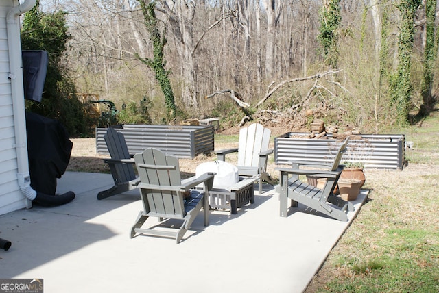 view of patio / terrace with a forest view and a grill