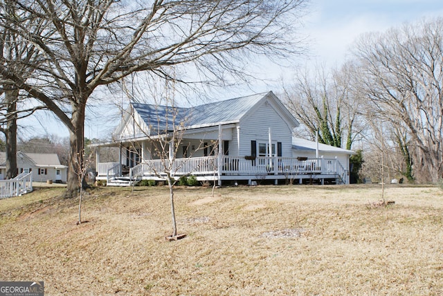 view of front facade with a porch and metal roof