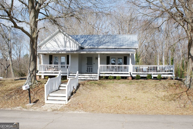 view of front of home with a porch and metal roof