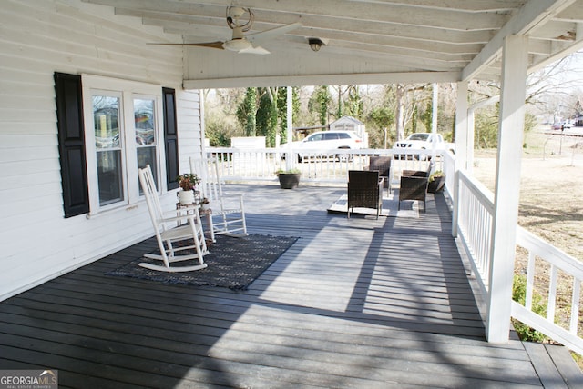 wooden terrace featuring a ceiling fan