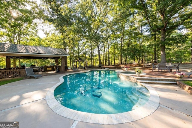 view of pool with a gazebo, a patio area, and a pool with connected hot tub