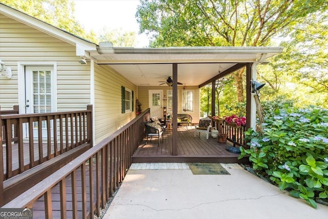 wooden terrace featuring a ceiling fan