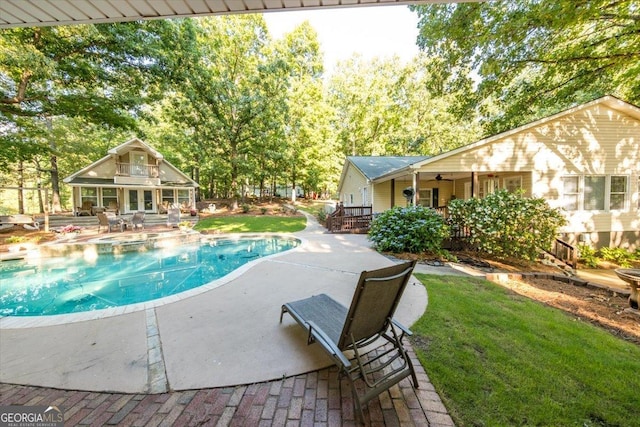 outdoor pool with a yard, an exterior structure, an outdoor structure, and a patio