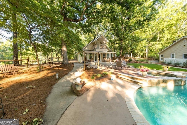 view of pool with a patio and fence