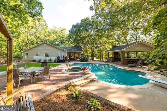 view of pool with a gazebo, a pool with connected hot tub, a diving board, and a patio