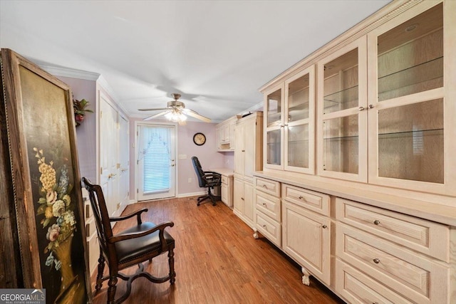 sitting room featuring ceiling fan, wood finished floors, built in study area, and baseboards