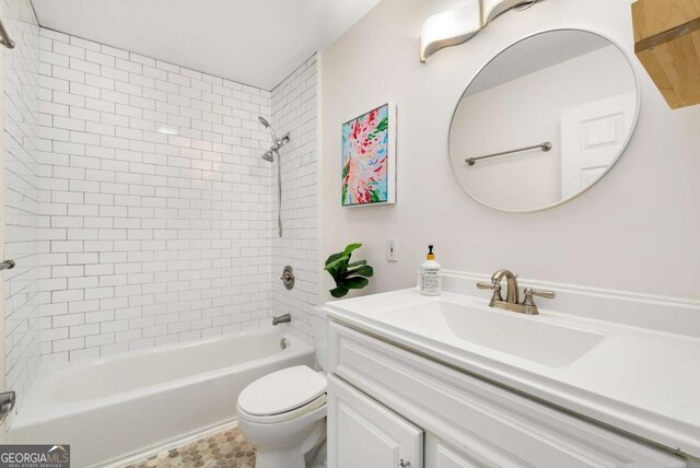 kitchen with white appliances, a sink, light countertops, stacked washer and dryer, and white cabinetry