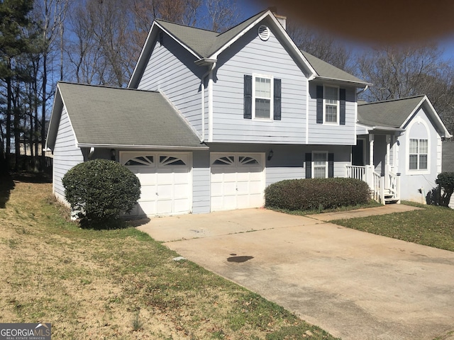 tri-level home featuring concrete driveway and a front yard