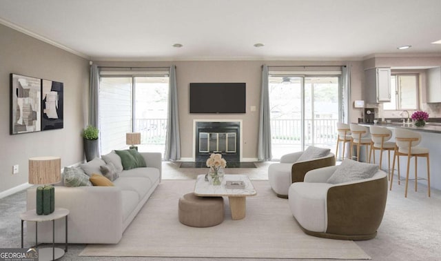 living room with a glass covered fireplace, carpet flooring, and plenty of natural light