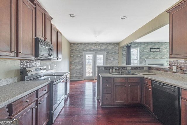 kitchen featuring decorative backsplash, a sink, black appliances, and dark wood-style floors