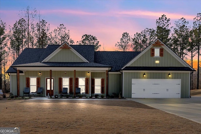 view of front of house with driveway, a garage, roof with shingles, a porch, and board and batten siding