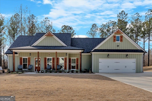 modern inspired farmhouse with a porch, a garage, a shingled roof, driveway, and board and batten siding