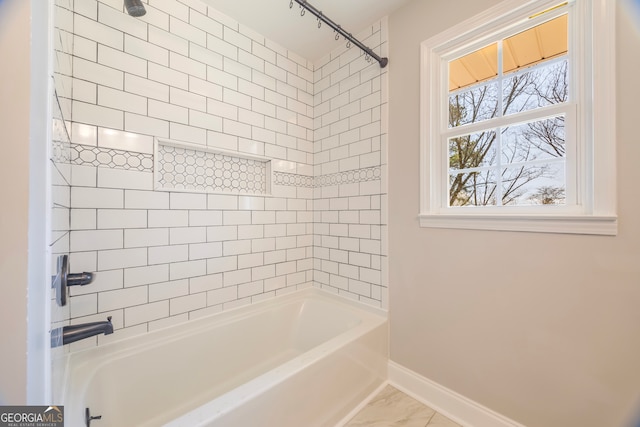 full bath with shower / bath combination and baseboards