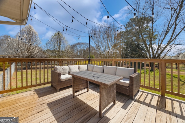 wooden terrace featuring a lawn and outdoor lounge area