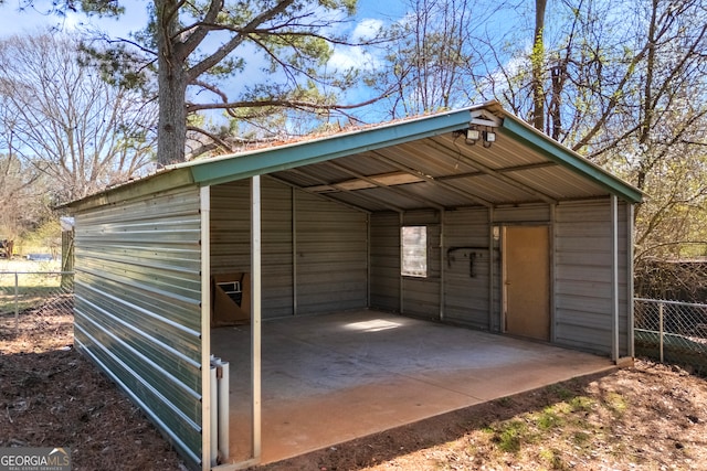 exterior space featuring a detached carport and fence