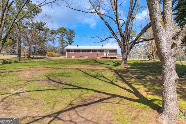 view of yard with fence and a wooden deck