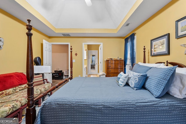 bedroom featuring ceiling fan, a raised ceiling, and visible vents