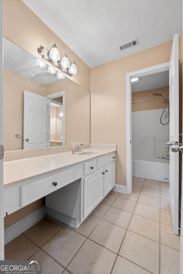 bathroom featuring visible vents, tile patterned flooring, a textured ceiling, vanity, and shower / bathing tub combination