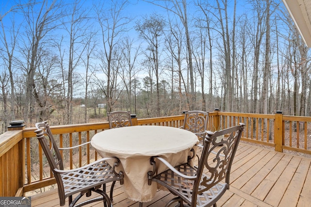 wooden terrace featuring outdoor dining area