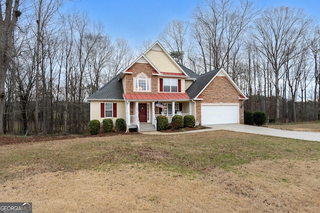 traditional-style house featuring a porch, an attached garage, brick siding, concrete driveway, and a front lawn