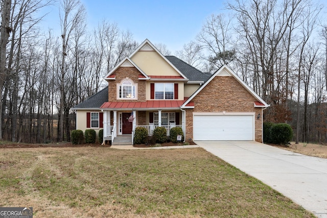 traditional home featuring a garage, concrete driveway, covered porch, a front yard, and stucco siding