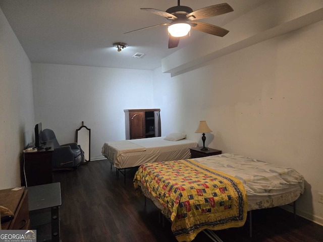 bedroom with visible vents, baseboards, ceiling fan, and wood finished floors