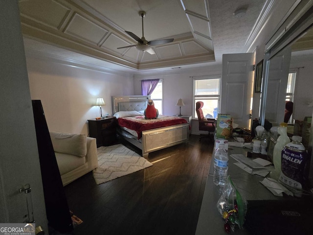 bedroom with a ceiling fan, crown molding, wood finished floors, and coffered ceiling