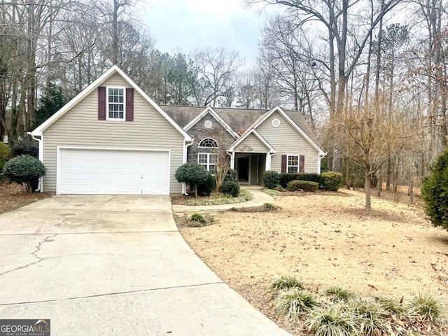 traditional-style house with a garage and concrete driveway