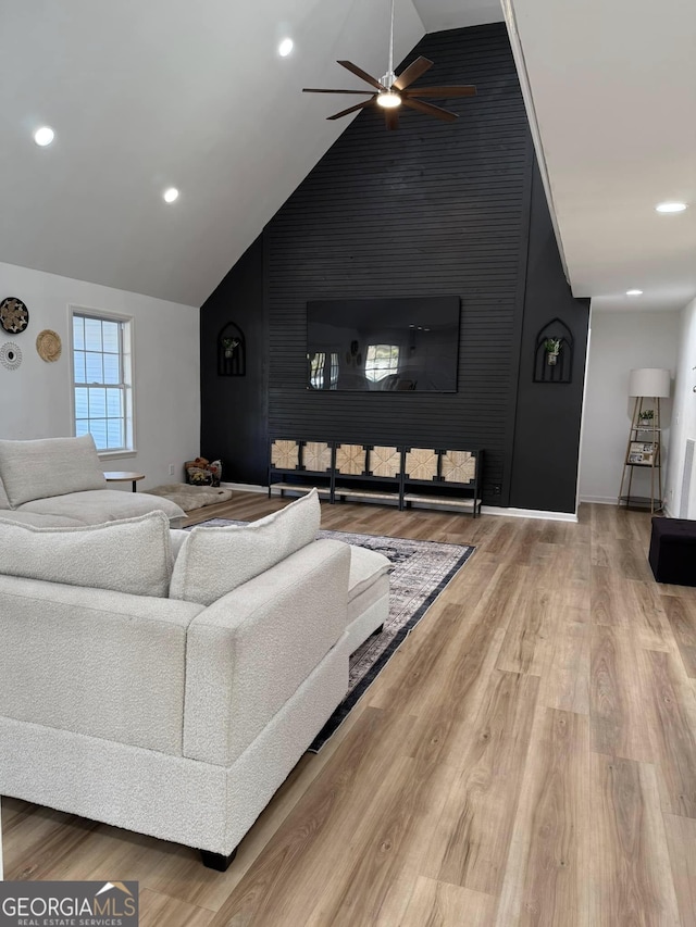 living room with recessed lighting, a ceiling fan, vaulted ceiling, wood finished floors, and baseboards