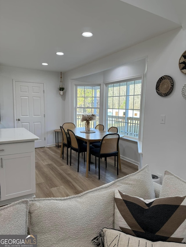 dining room featuring light wood-style floors, recessed lighting, and baseboards