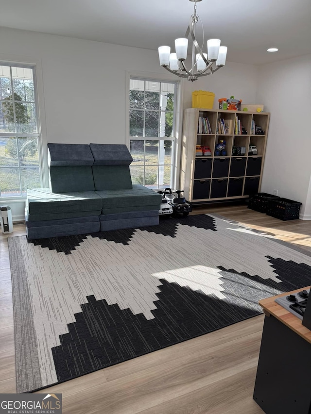 interior space with recessed lighting, wood finished floors, and an inviting chandelier