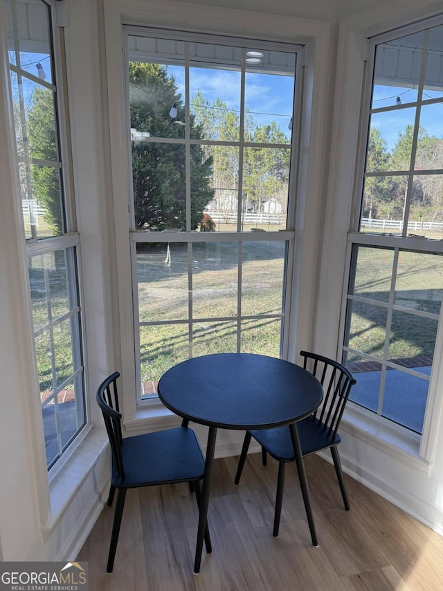 dining room with plenty of natural light and wood finished floors