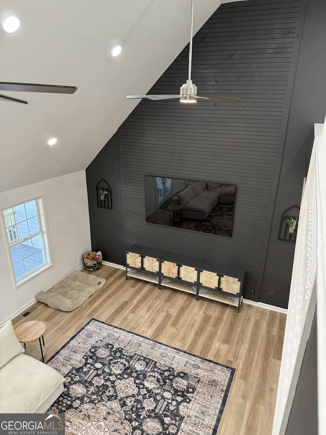 living area with recessed lighting, vaulted ceiling, ceiling fan, and wood finished floors