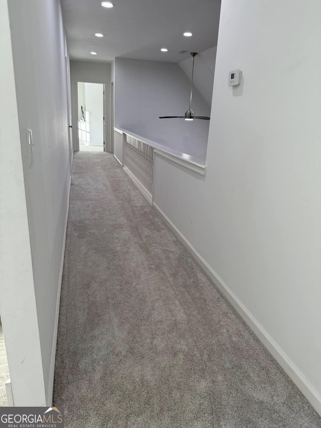 hallway featuring baseboards, carpet flooring, and recessed lighting