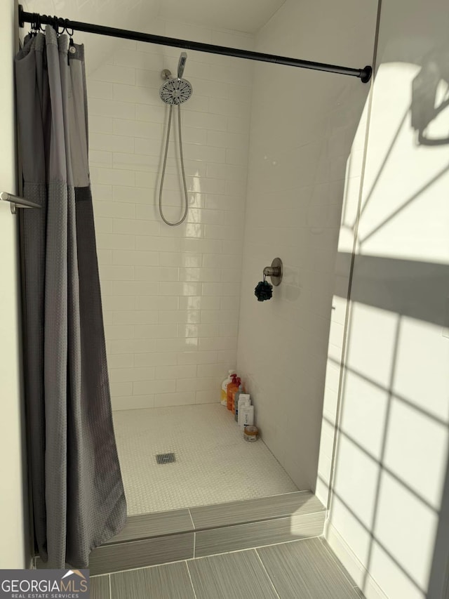 full bathroom with a shower stall and tile patterned floors