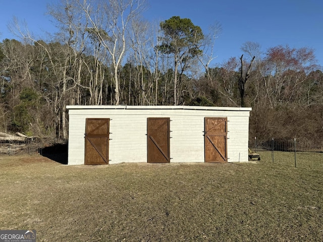 view of outbuilding with a view of trees and an outbuilding