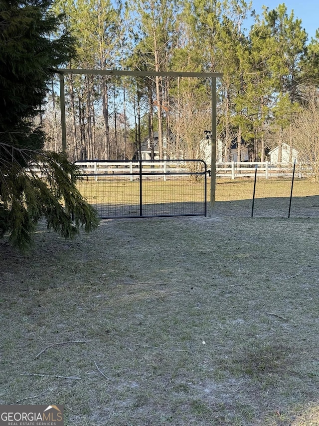 view of home's community with fence and a gate