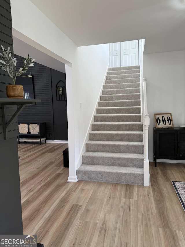 stairway featuring baseboards and wood finished floors