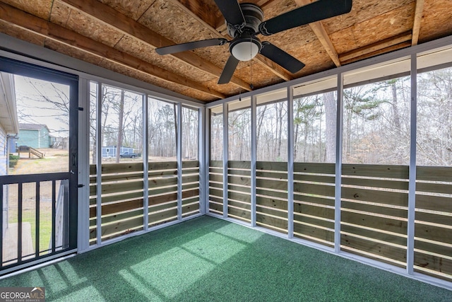 unfurnished sunroom featuring a ceiling fan