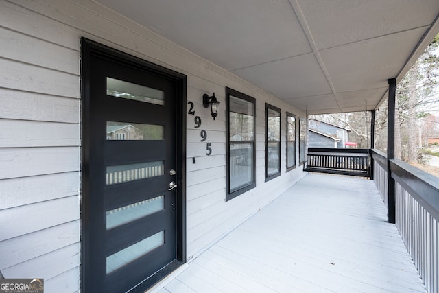 view of exterior entry featuring covered porch