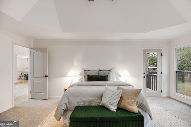 bedroom with light carpet, access to outside, baseboards, and a raised ceiling