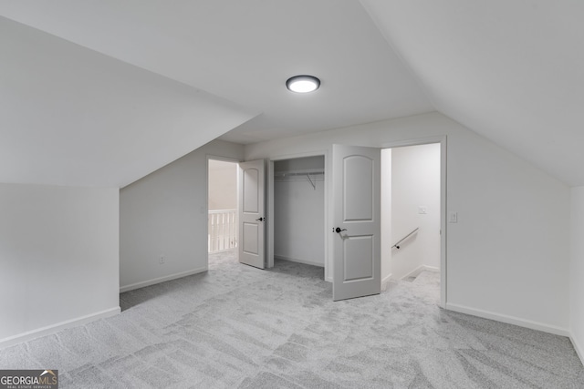 additional living space featuring lofted ceiling, carpet flooring, and baseboards