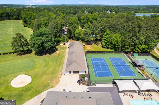 drone / aerial view featuring a water view and a wooded view