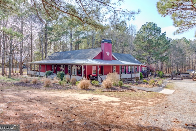 view of front of home with covered porch and fence