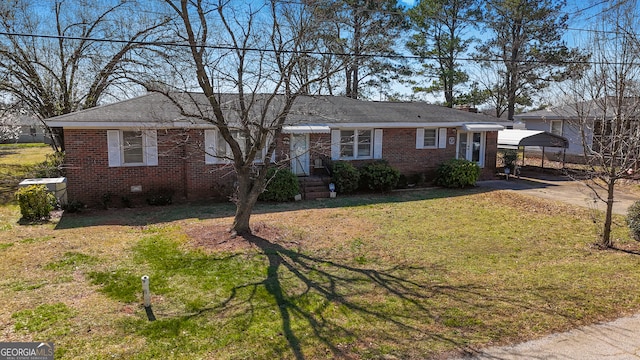 ranch-style home featuring driveway, brick siding, crawl space, and a front lawn