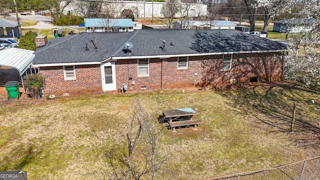 rear view of house featuring a shingled roof, crawl space, brick siding, and a lawn