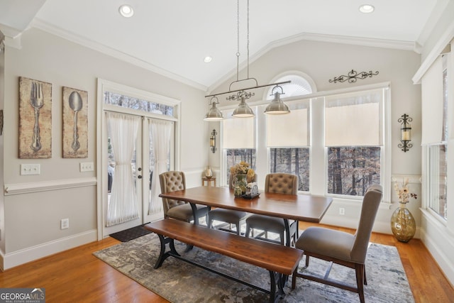 dining area featuring vaulted ceiling, light wood-style flooring, and recessed lighting