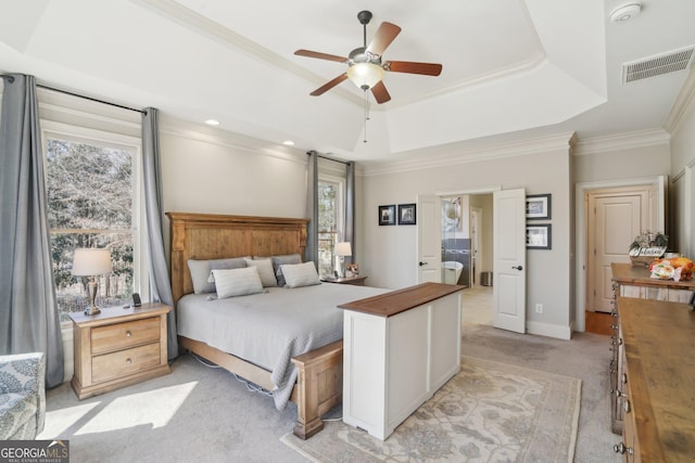bedroom featuring light carpet, a raised ceiling, visible vents, and multiple windows
